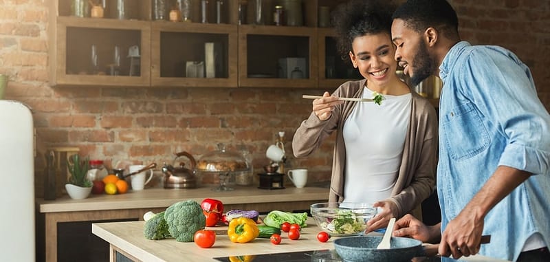 african-american couple preparing a detox meal